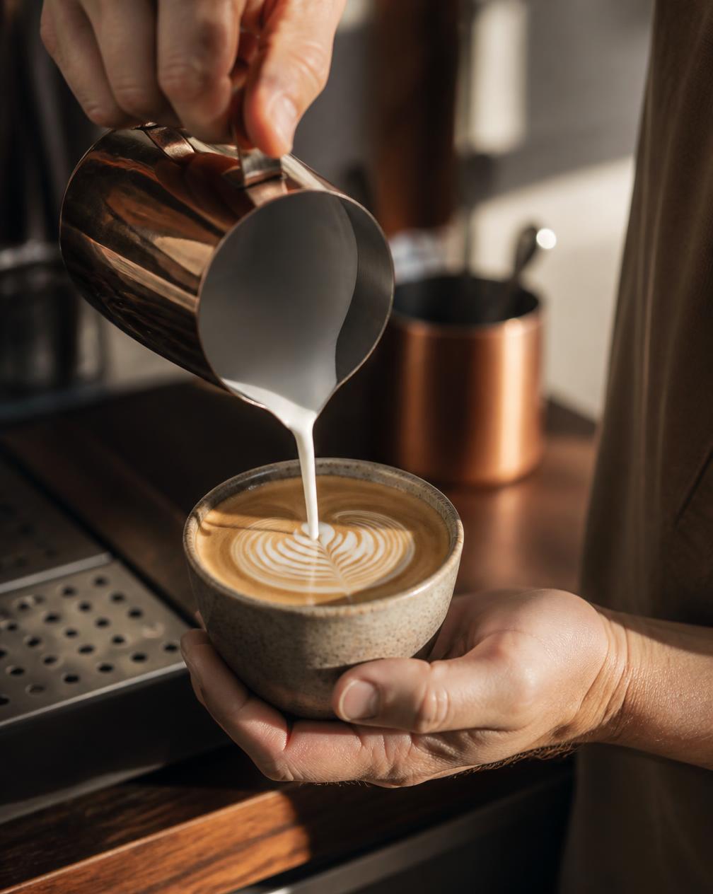 Fresh latte being poured